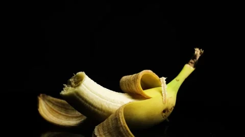 Rotating Banana on Dark Background Close Up Stock Footage 329966326