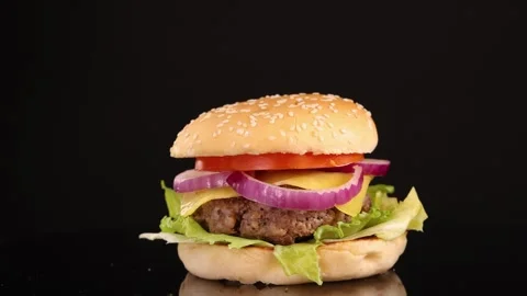 Rotating Beef Burger on Black Background in Studio Lighting Stock Footage 313270767