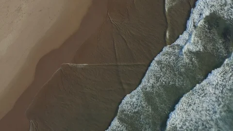 Rotating Birds Eye View Of Empty Beach And Ocean Waves Stock Footage 128845342