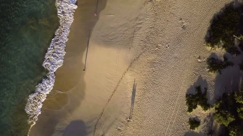 Rotating Birds Eye View Of Man Walking Along A Secluded Tropical Beach Stock Footage 85065235