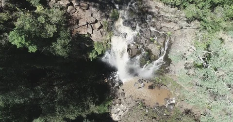 Rotating birdseye view of waterfall going over cliff Video stock 97417741