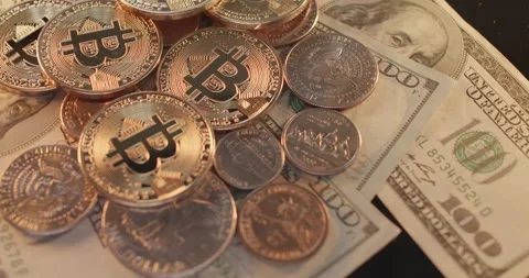 Rotating Bitcoin and US Dollar banknotes, trading Crypto and NFT in the USA Stock Footage 177124010
