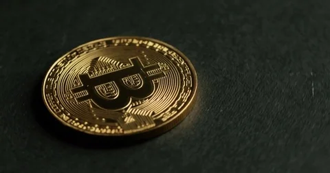 Rotating Bitcoin on a black background Vídeo Stock 79036264