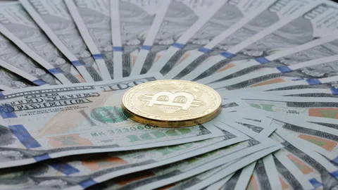 Rotating Bitcoin crypto currency stacked with 100 dollar bills. Diferent Stock Footage 194649436