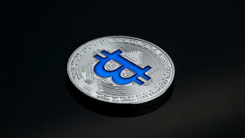 Rotating bitcoin cryptocurrency silver coin blue logo black backround business Stock Footage 87257118