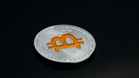 Rotating bitcoin cryptocurrency silver coin gold logo black backround business Stock Footage 87257285