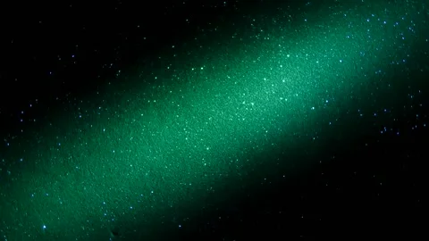 Rotating black background with flashing light beams in pink and turquoise 動画素材 242347935