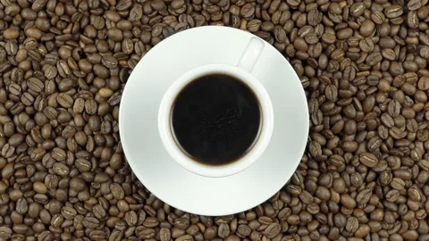 Rotating Black Coffee On Coffee Beans. Stock Footage 196086957