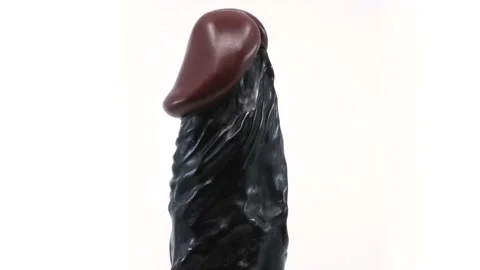Rotating Black dick head Stockbeeldmateriaal 219091857