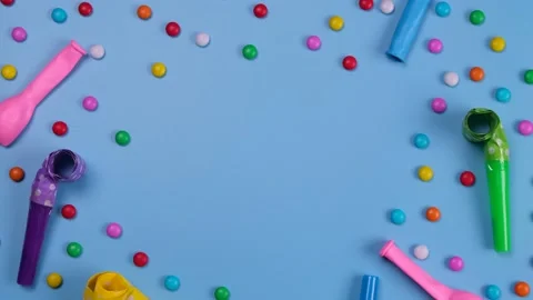 Rotating blue background with candies, balloons and pipes for a celebrated Stock Footage 196473290