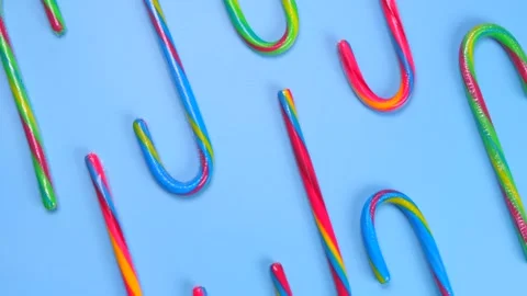 Rotating blue background with multi-colored candy canes, New Year holidays and Stock Footage 198235685