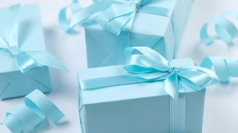 Rotating blue gift boxes with blue bows on a blue background,, the concept of Stock Footage 212045834