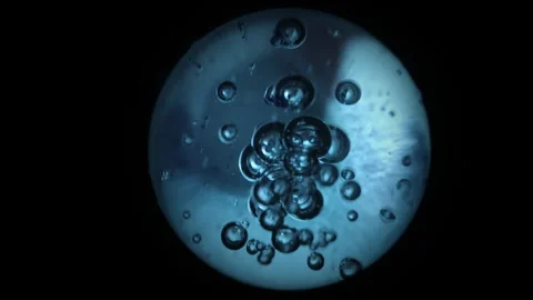 Rotating blue sphere with air bubbles inside on a black background. molecule 動画素材 275052607