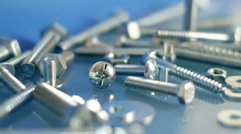 Rotating bolts and nuts on workbench. Stock Footage