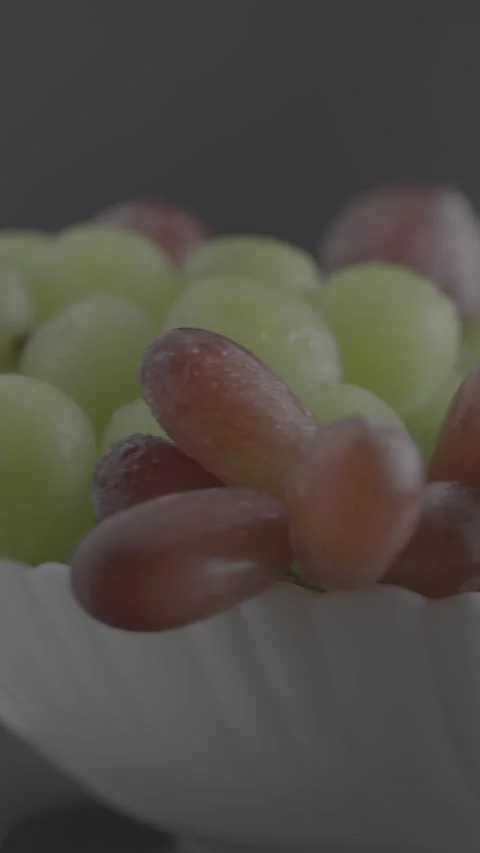 Rotating Bowl of Red and Green Grapes on Dark Background Stock Footage 344801805