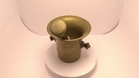 Rotating brass mortar and pestle on white background – product video Stock Footage 336974944