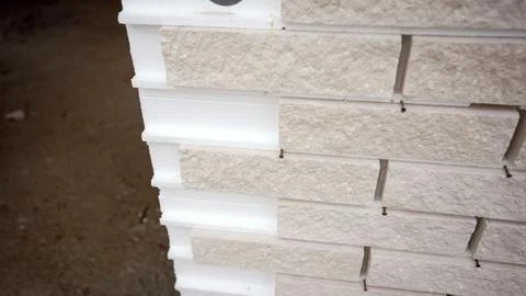 Rotating brick and insulation panel for energy efficient building Fotos de archivo