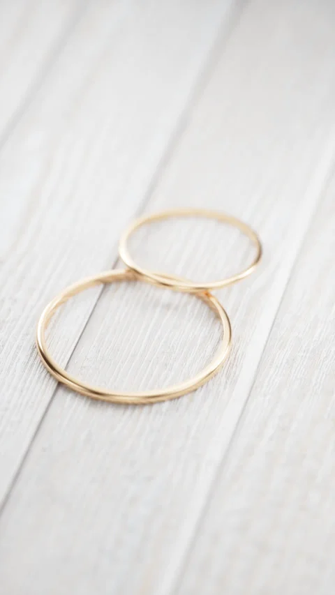 Rotating the camera around two gold wedding rings. Stock Footage 250149091