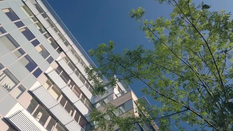 Rotating camera movement in front of modern office building windows reflecting Stock Footage 122212514
