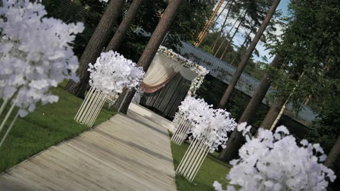Rotating camera shot of wedding ceremony decoration in the forest.  Stock Footage 131396656