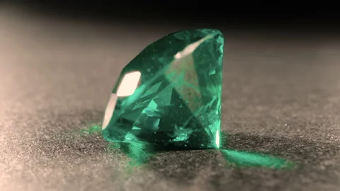 Rotating camera shots of isolated lying big green emerald. Treasure jewels. Video stock 160889879