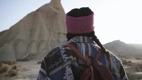 Rotating camera young backpacker enjoying sunny day in desert bardenas Stock Footage 254211344