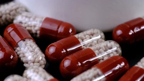 Rotating capsule medications with granules inside Stock Footage 218318074