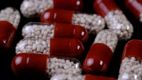 Rotating capsule medications with granules inside Stock-Footage 218318146