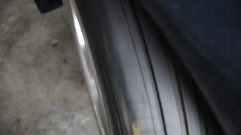 Rotating a car wheels for checking car suspension Stock Footage