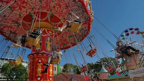 Rotating carousel in an amusement park on a sunny day. Stock Footage 155936272