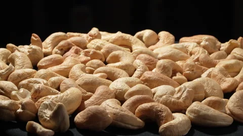 Rotating Cashew Nuts with Backlight on Black Background. Stock Footage 332837494