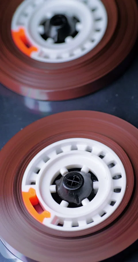 Rotating cassette tape reels in macro detail Stock Footage 345002728