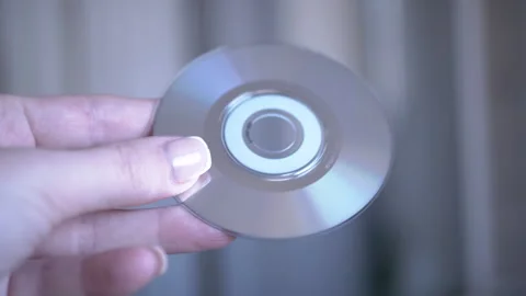 Rotating CD Close-Up in hand Video stock 312008330