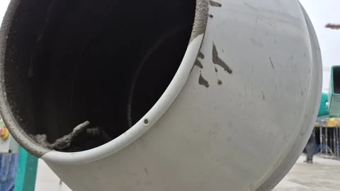 Rotating Cement Mixer Drum with Builder Working in Background Stock Footage 332506481