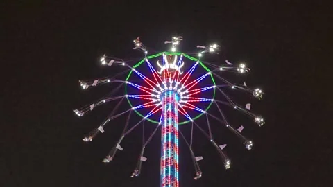 Rotating Chain Swing Ride with Bright Lights at Night Stock Footage 341623684