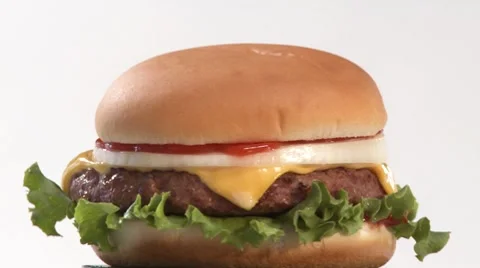 A rotating cheeseburger Stock Footage 8570815
