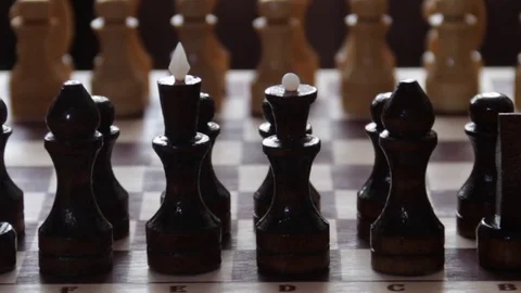 Rotating chessboard with chess pieces on a dark background. The rotating concept Stock Footage 74356161