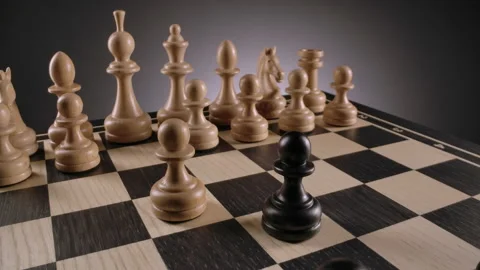 Rotating chessboard with lines of white and black wooden chess figures Stock Footage 166843699