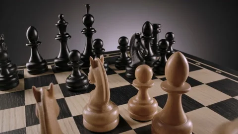 Rotating chessboard with lines of white and black wooden chess figures Stock Footage 166844004