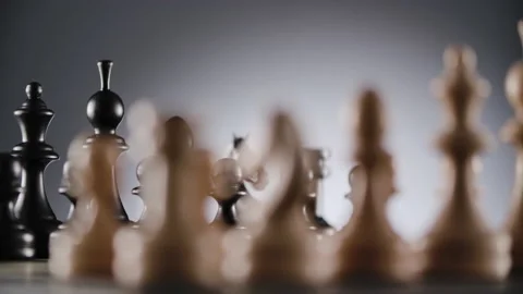 Rotating chessboard with lines of white and black wooden chess figures Stock Footage 166846396