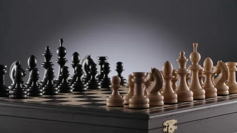 Rotating chessboard with lines of white and black wooden chess figures Stock Footage 166847868