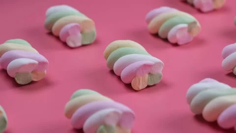 Rotating chewy marshmallows on a pink background Stock Footage 201960291