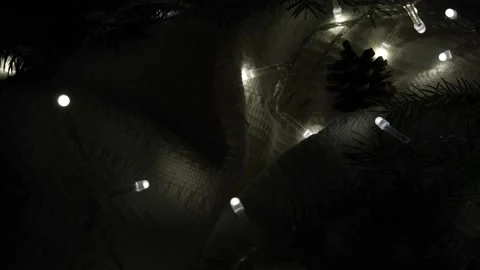 Rotating christmas background with white plaid and lights a garland in the dark Stock Footage 167450670
