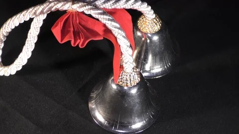 Rotating christmas bells on black surface Stock Footage 111273888