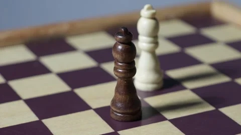 Rotating cinematic shot of chess queens, dancing shadows on a chessboard. Stock Footage 314378081