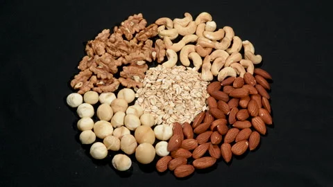 Rotating Circular Mix of Healthy Nuts and Rolled Oats. Stockbeeldmateriaal 332830183
