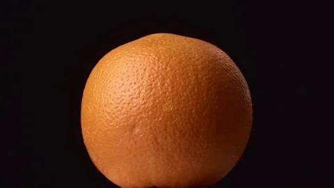 Rotating citrus orange on black background. Stock Footage 325988106