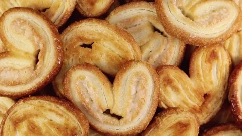 Rotating close up of fresh palm puff pastry in the shape of a heart. Stock Footage 140205248