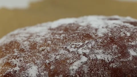 Rotating close-up of a gingerbread cookie dusted with powdered sugar. Stock Footage 299032533