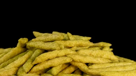 Rotating Close-Up of Green Pea Crispy Snack Sticks Stock Footage 319522501